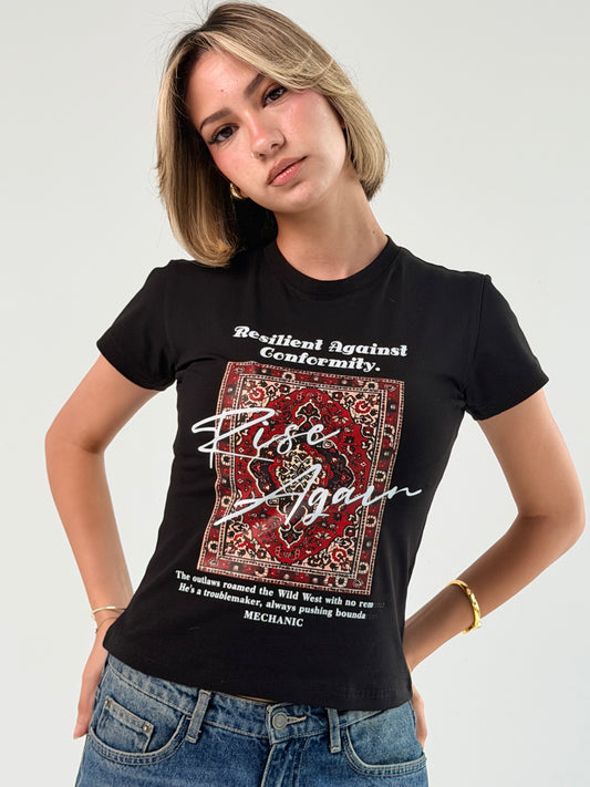 Person wearing a black t-shirt with graphic design and text on a plain background